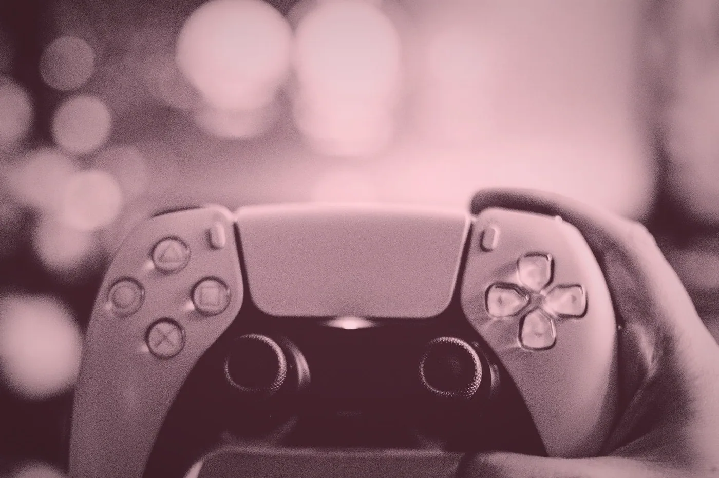 A close view of a keyboard and a headset on a table next to a stack of game boxes